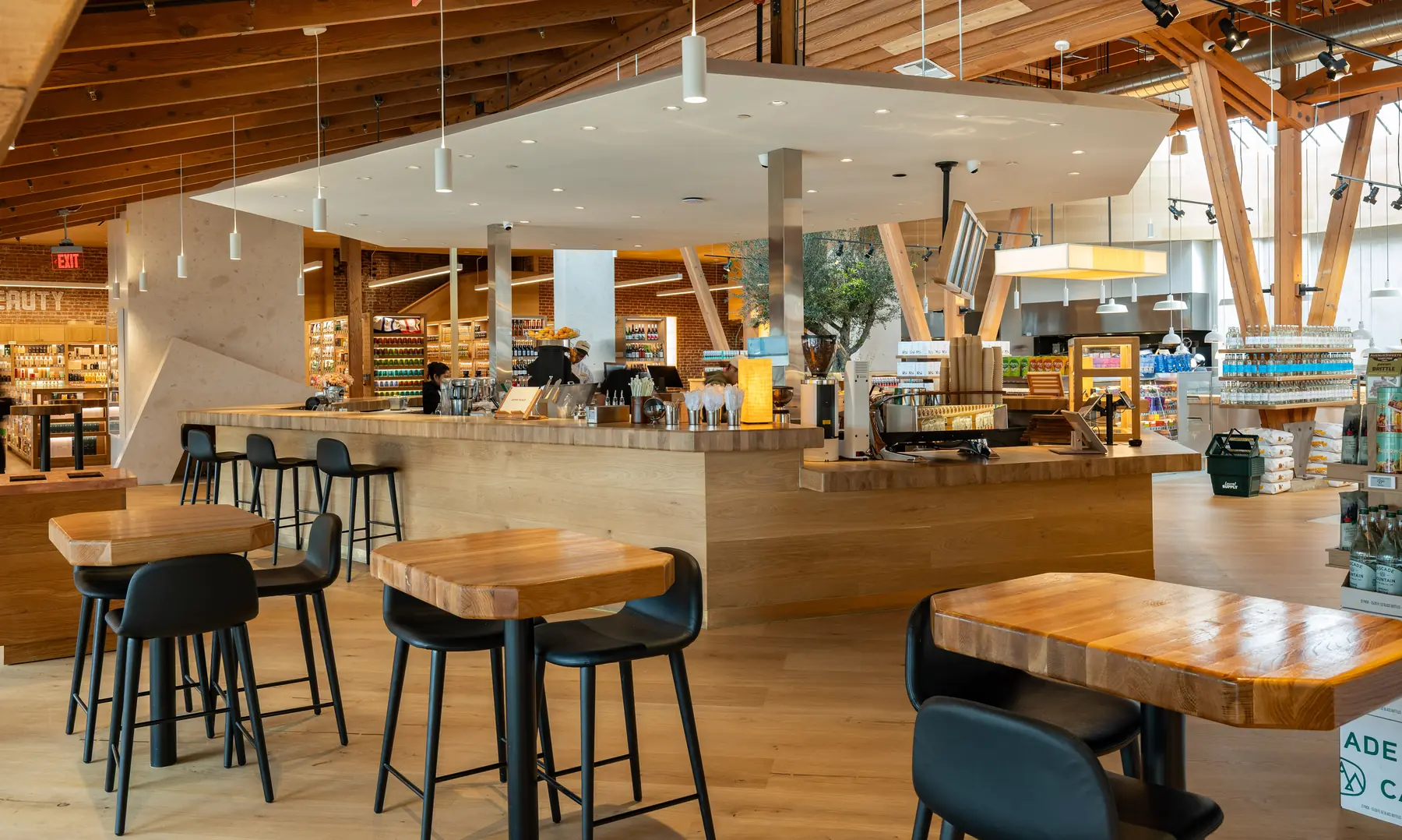 Café seating with tall tables around the coffee bar